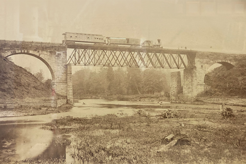 A train crossing the iron, double-truss railroad bridge over the Ashtabula River prior to the span’s failure (photo courtesy of the Ashtabula Maritime & Surface Transportation Museum)