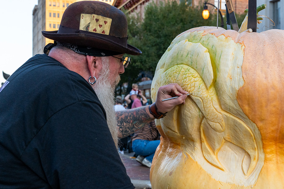 Man carving pumpkin at Hamilton’s Operation Pumpkin (photo by Justin Sheldon of Cincy Visuals)